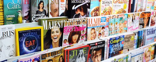 Line of multicolored magazine covers.