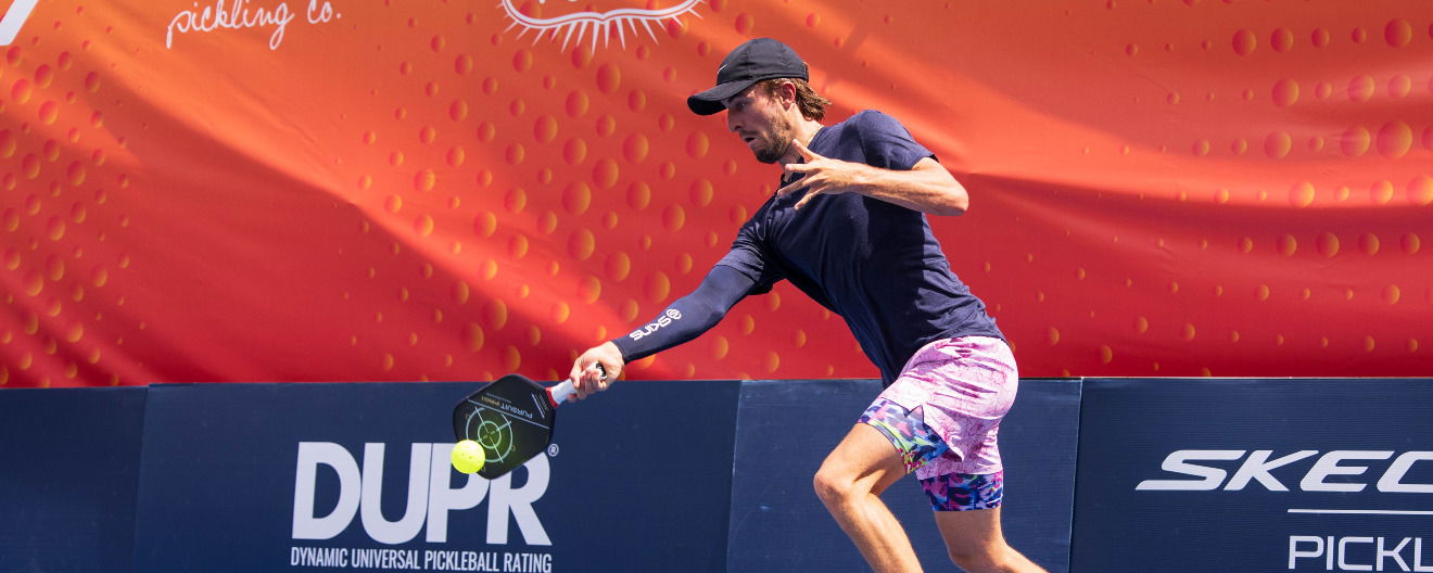 Hunter Johnson hits a forehand.