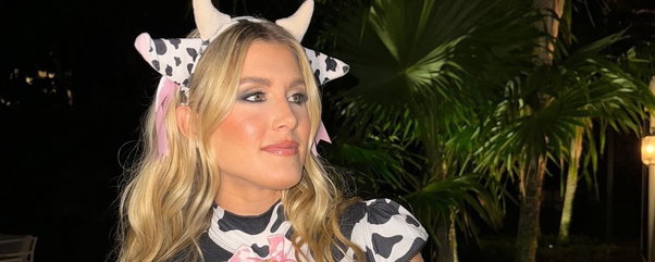 Genie Bouchard wearing cow ears on her head in a cow printed top