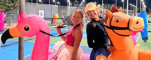 Mary and Maggis Brascia in inflatable halloween costumes on the pickleball court.