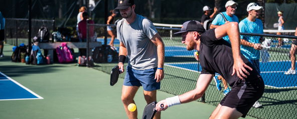 Players competing on a pickleball court.
