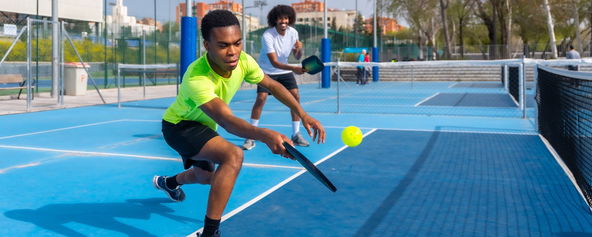 Two men playing pickleball.