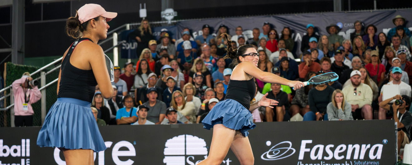 Rachel Rohrabacher and Anna Bright playing women's doubles.