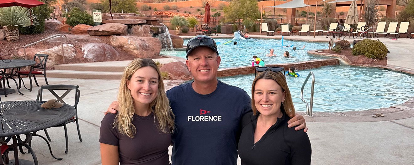 Vinnie with his arms around Mary and Maggie's shoulders standing in front of the pool