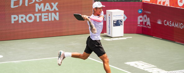 Quang Duong hitting a pickleball backhand.