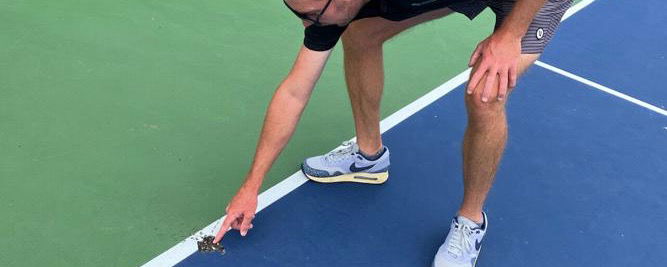 Longview Pickleball Club President Dustin Eberhart points to the damage.