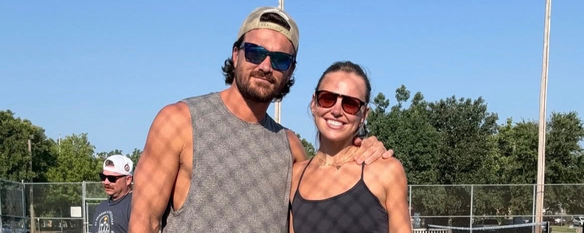 Adam Woolard with his arm around Hannah Brown at the pickleball courts.