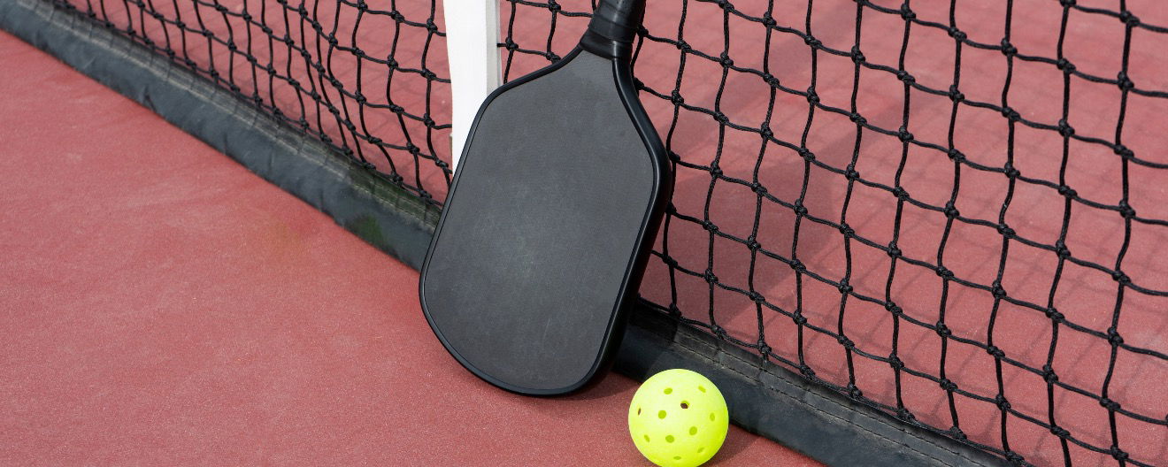 A pickleball paddle and ball.