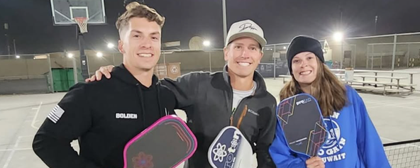 Danny Jensen posing with two people in Kuwait.
