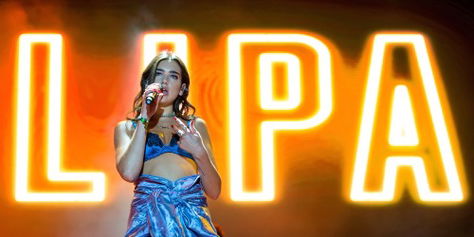 Dua Lipa singing on stage.