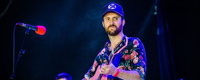 Ruston Kelly performing on stage.