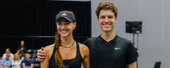 Helena Spiridis and Tom Evans with their arms around each other on the court.