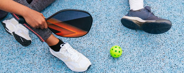 People showing their pickleball shoes.