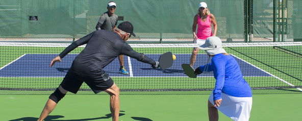 Players competing on the pickleball court.