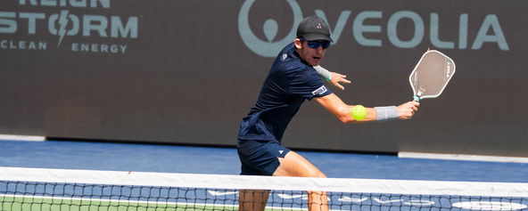 John Lucian Goins hitting a bachand volley.
