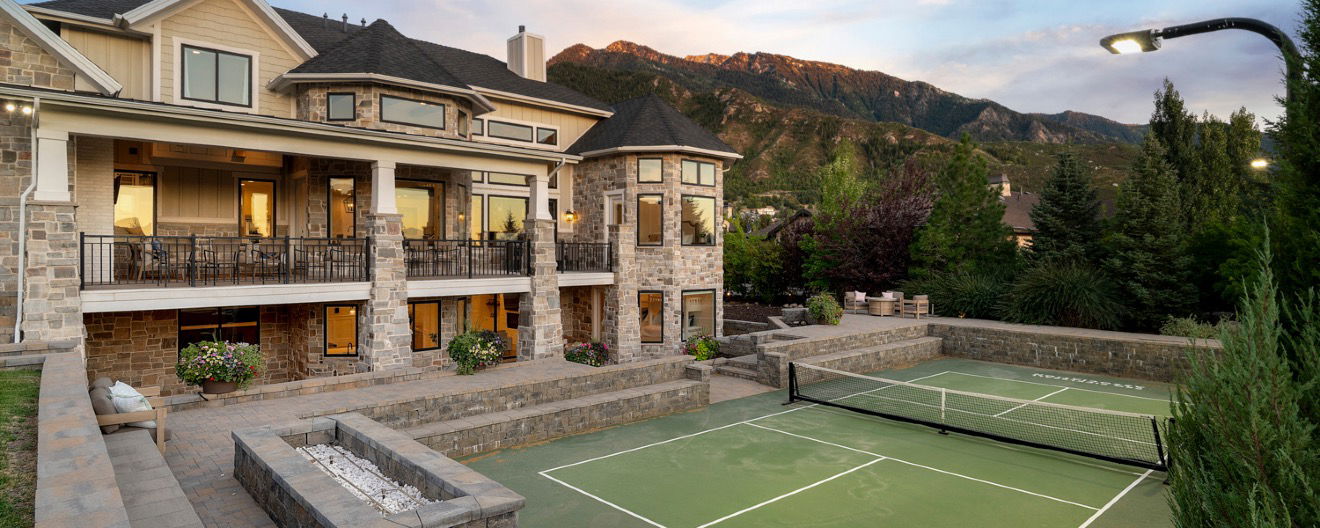A pickleball court in the backyard of a home.