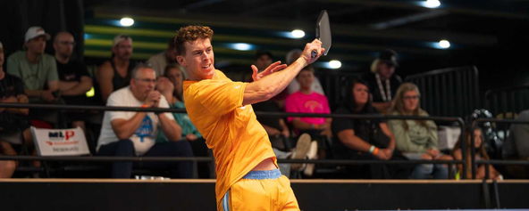Grayson Goldin hitting a serve.