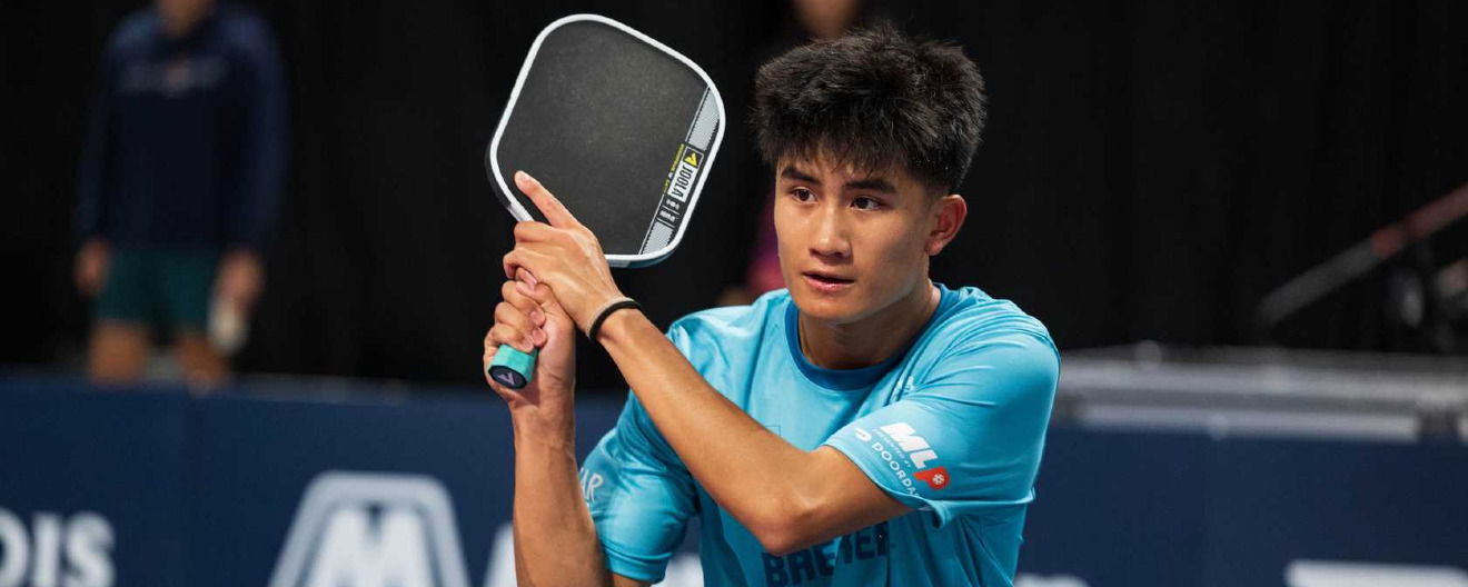 Jonathan Truong hitting a backhand.