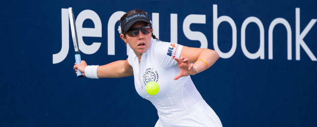 Jorja Johnson hitting a serve.