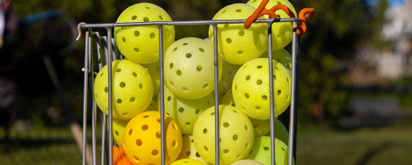 A bucket of pickleballs.