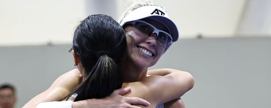 Meghan Dizon and Alix Truong embrace after winning gold in women's doubles.