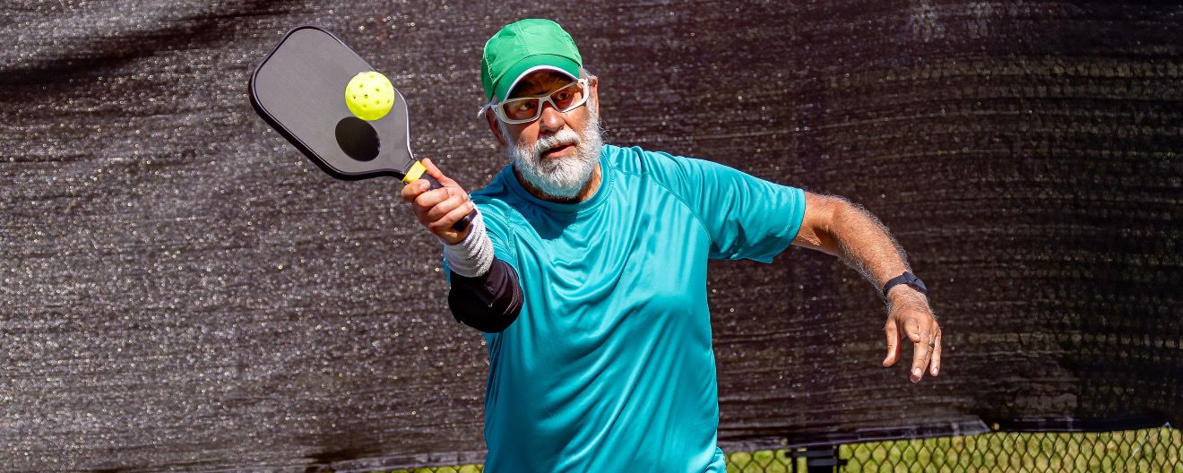 A man playing pickleball.