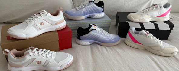 Three pairs of pickleball court shoes on display.