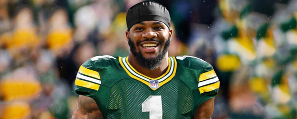 Micah Parsons smiling in a Green Bay Packers jersey.