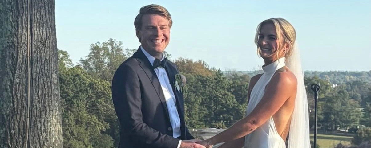 Kate Fahey and her new husband, Charlie holding hands on their wedding day