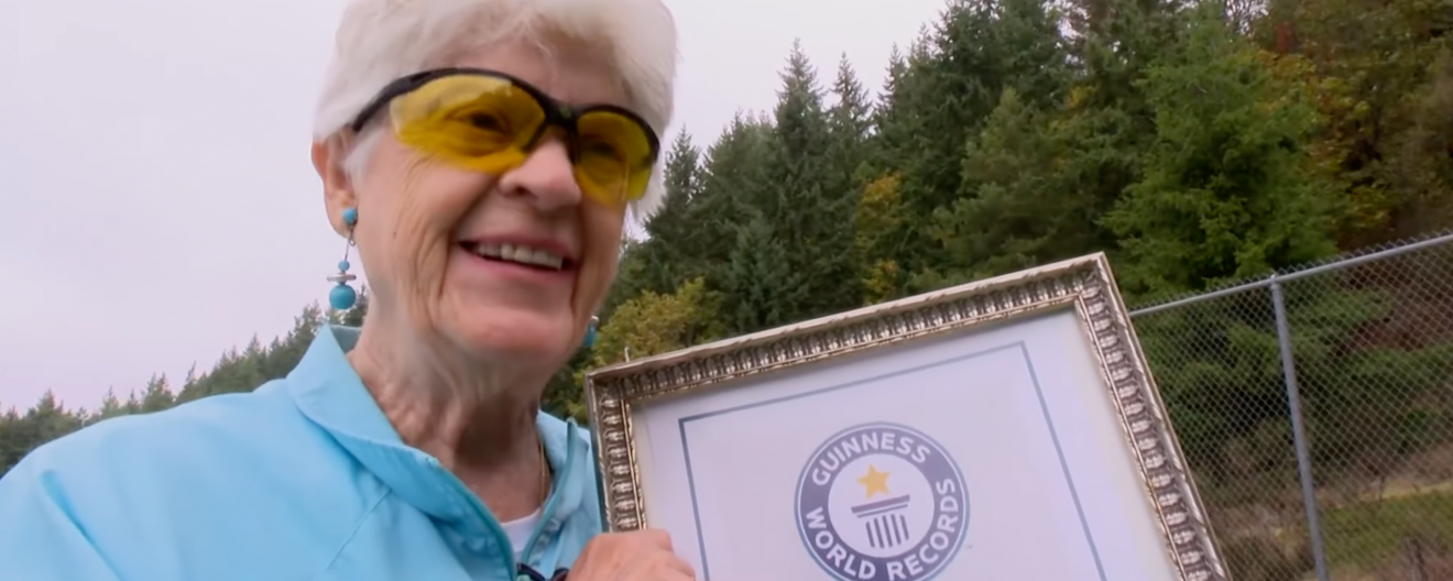 Joyce Jones posing with a Guinness World Record certificate.