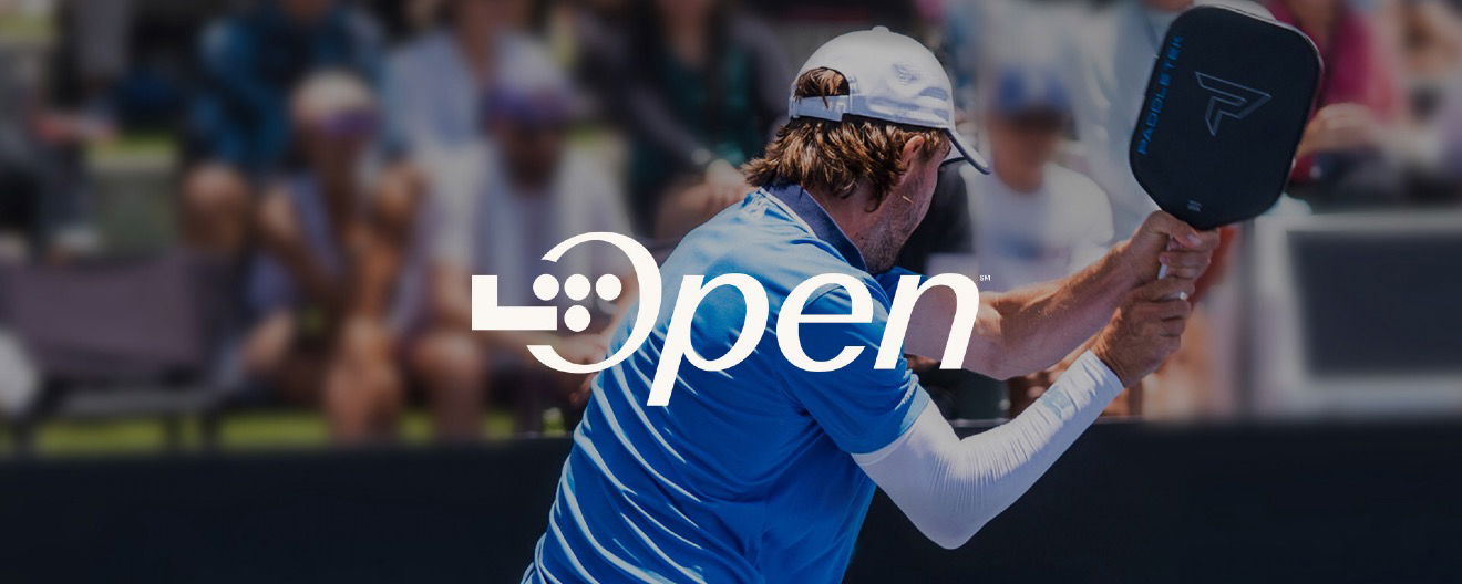 A player hitting a pickleball.