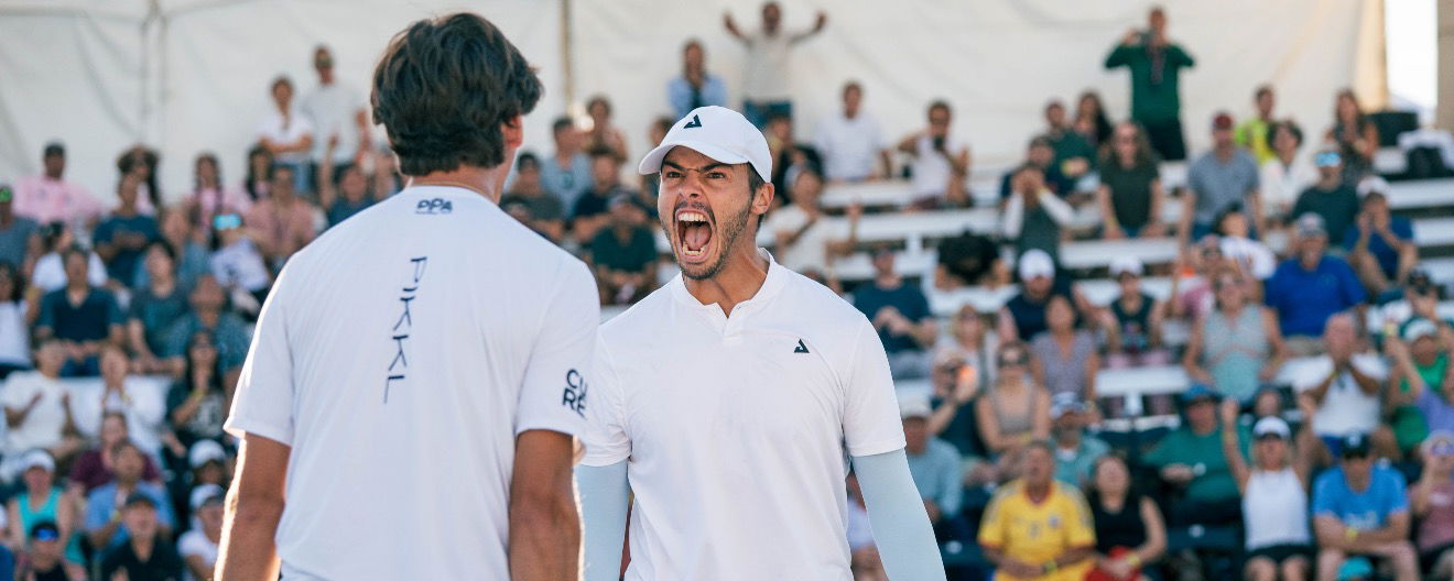 Ben Johns yells out in victory to partner Gabe Tardio after a grueling five game match win