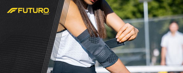 A woman putting on a compression sleeve.
