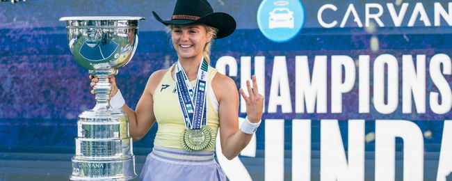Anna Leigh Waters posing with her medals on Championship Court.