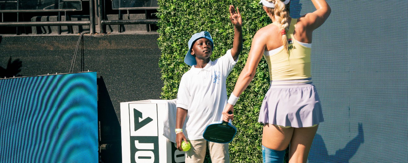 Micah Yeboah and Anna Leigh Waters exchange a high five at Worlds.
