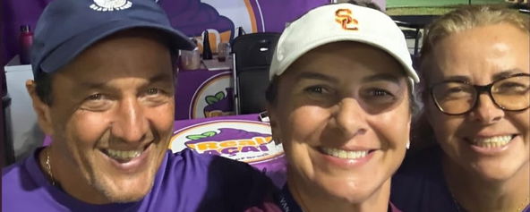 Three people smiling in a group photo.