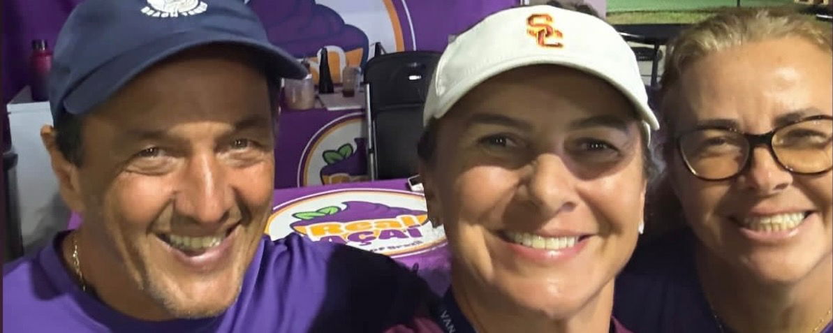 Three people smiling in a group photo.