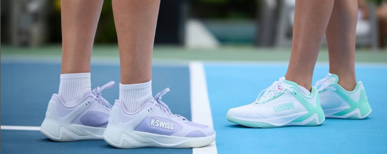 A close-up of two people wearing K-Swiss court shoes.