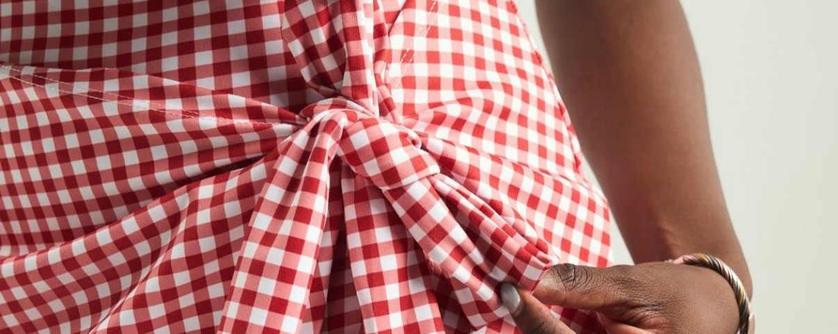 Close up of ELN's picnic table red and white wrap dress