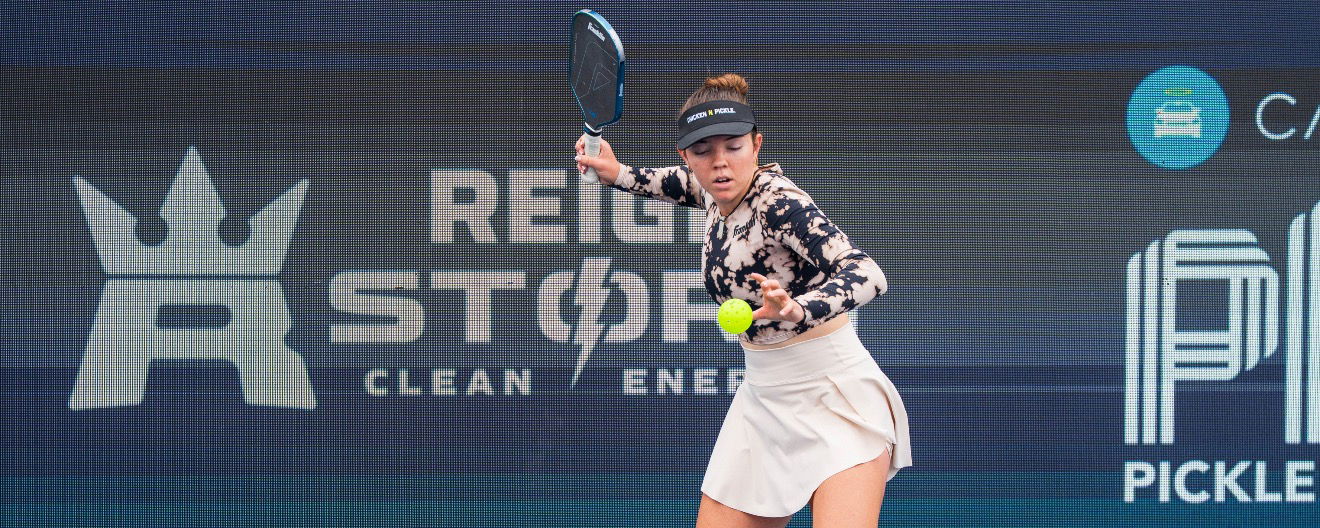 Jorja Johnson in a longsleeve tie-dye top and cream skirt.