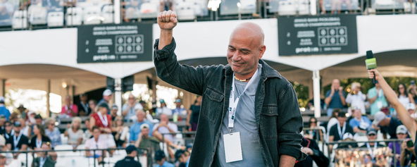 Andre Agassi throwing his arm up in a fist pump.