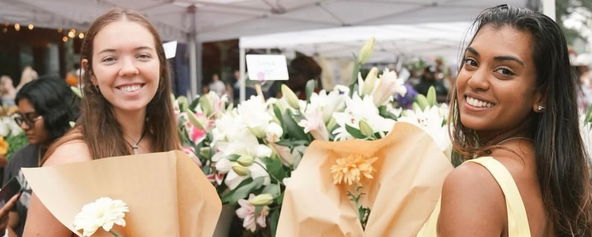 Jorja and Milan holding bouquets of flowers.