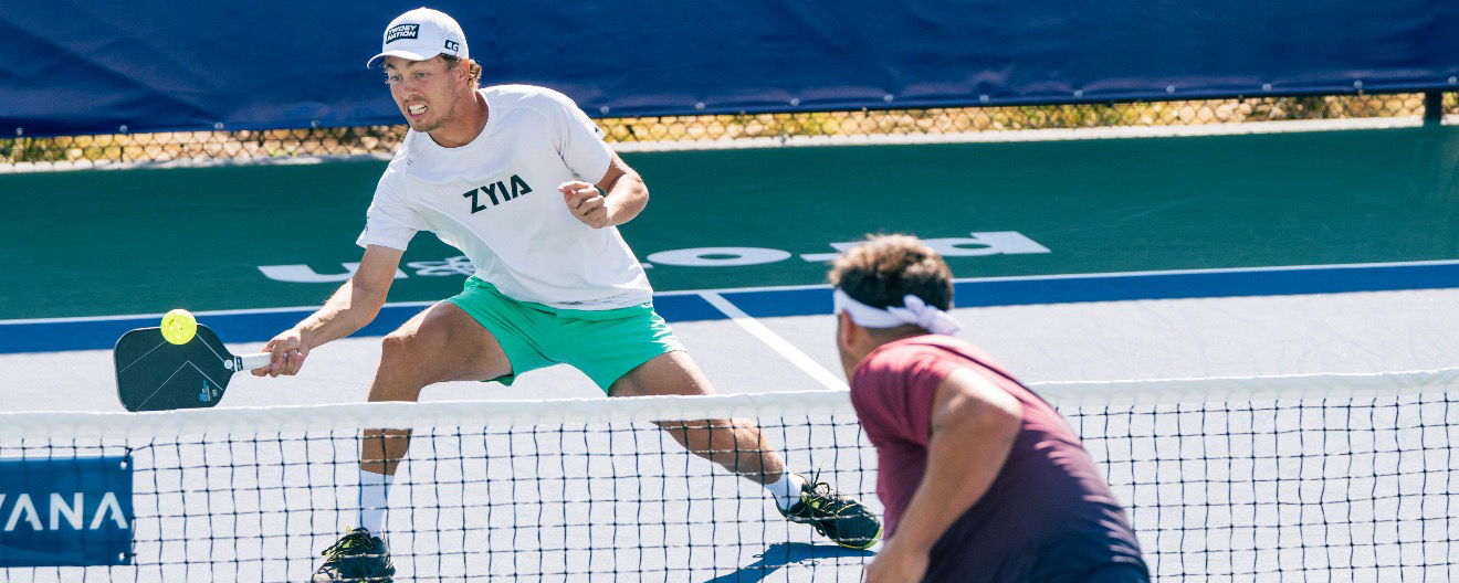 Connor Garnett hitting a dink on the pro pickleball court.