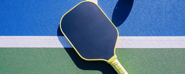 A paddle on a pickleball court.