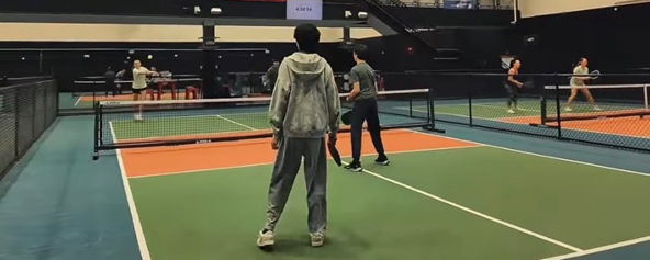 Students on a pickleball court.