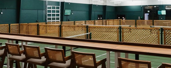 Chairs overlooking a pickleball court at St. Pete Athletic.