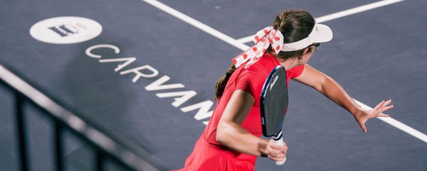 Johnson wearing a red dress and white hairbow with red hearts on it.