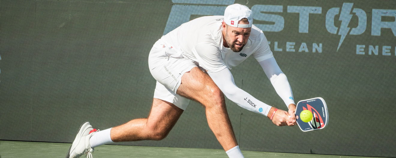 Jack Sock hitting a pickleball backhand.