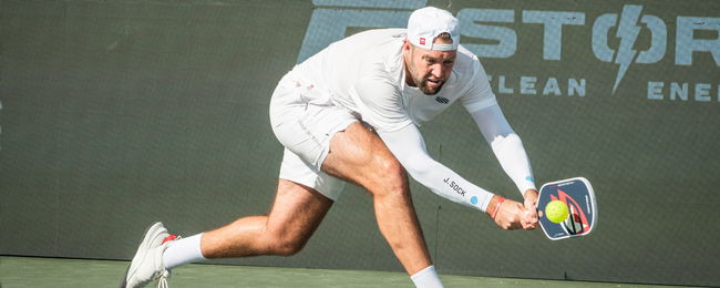 Jack Sock hitting a pickleball backhand.