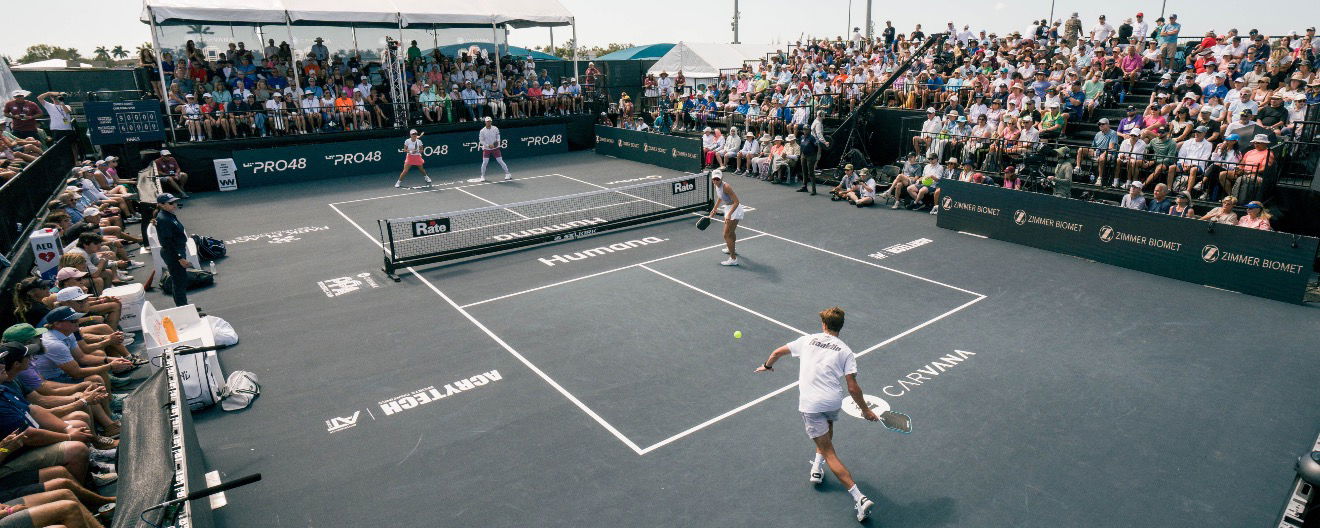 A mixed doubles pro pickleball match .